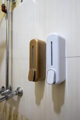 a soap dispenser on the wall of a bathroom at Simba homes in Arusha