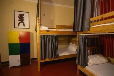 a dorm room with three bunk beds in it at Simba homes in Arusha