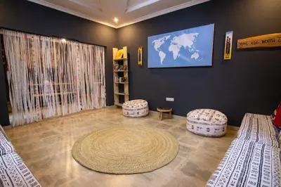 a living room with two beds and two ottomans at Simba homes in Arusha
