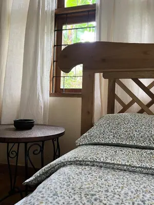 a bedroom with a bed and a window at Nature's Haven Ilboru Hideaway in Arusha