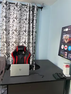 a desk with a laptop and a monitor on it at MSF BACHELOR PAd in Arusha