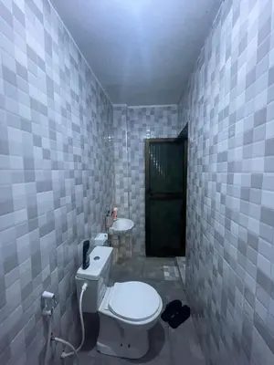 a bathroom with a toilet and two sinks in it at MSF BACHELOR PAd in Arusha