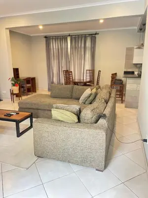 a living room with a couch and a table at Attorney Pad in Arusha