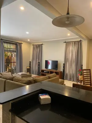 a living room with a couch and a flat screen tv at Attorney Pad in Arusha