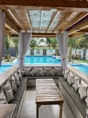 a pool room with a couch and a table at Luxurious 2bed in Arusha