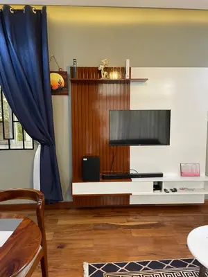 a living room with a flat screen tv on a table at Luxurious 2bed in Arusha