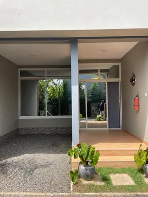 a house with large windows and a wooden porch at Luxurious 2bed in Arusha