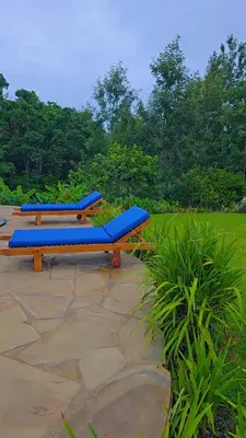 a row of blue benches sitting on a patio at Daima Escape in Usa River