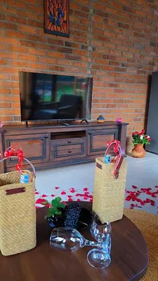 a living room with two baskets on a table in front of a tv at Daima Escape in Usa River