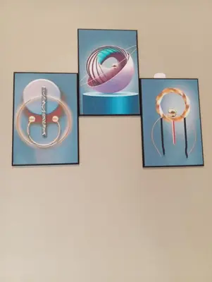 four framed pictures of rings on a wall at Elwood Lodge in Arusha