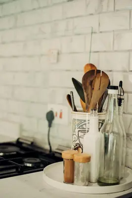 a kitchen counter with a container of utensils and a stove at Garden Villa by Wedelia Homes in Tengeru