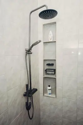 a shower with a shower head in a bathroom at Garden Villa by Wedelia Homes in Tengeru