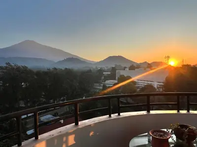 a view of the sunset from a balcony at Tai Africa Apartment in Arusha