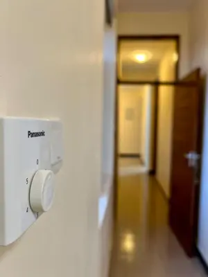 a room with a light switch and a hallway at Tai Africa Apartment in Arusha
