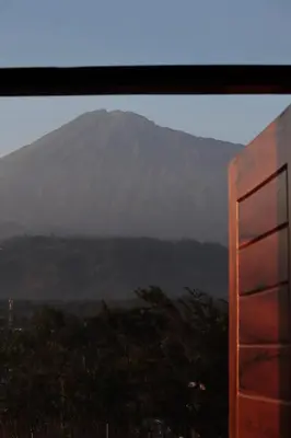 a view of a mountain from a window at Tai Africa Rooms in Arusha