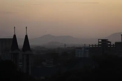 a view of a city with mountains in the background at Tai Africa Rooms in Arusha