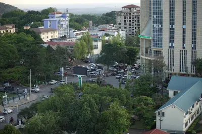 a view of a city street with cars and buildings at Tai Africa Rooms in Arusha