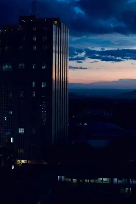 a tall skyscraper in a city at night at Tai Africa Rooms in Arusha