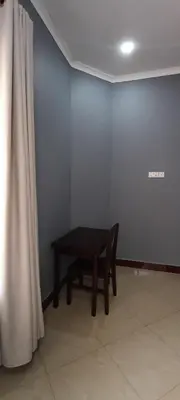 a black table in a room with a curtain at Nguchiro Palace Hotel in Moshi