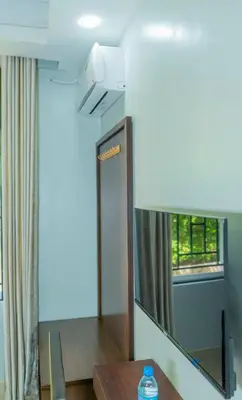 a living room with a mirror and a table at Nguchiro Palace Hotel in Moshi