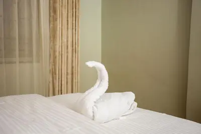 a swan made out of towels on a bed at Nguchiro Palace Hotel in Moshi