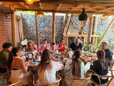 a group of people sitting at a table in a restaurant at Serengeti Home in Arusha