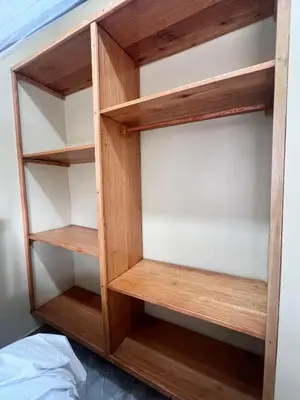 a wooden book shelf in a bedroom at Boma villa kilimanjaro in Boma la Ngombe