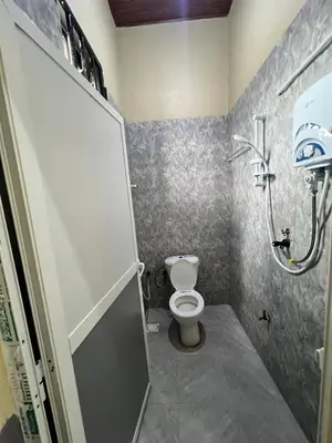 a bathroom with a toilet and a shower stall at Boma villa kilimanjaro in Boma la Ngombe