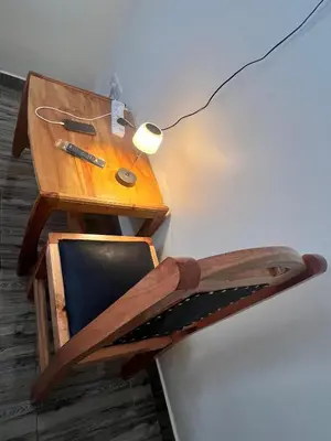 a wooden desk with a chair and a lamp at Boma villa kilimanjaro in Boma la Ngombe