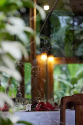 a table with glasses and a bottle on it at Arusha Farm House in Arusha