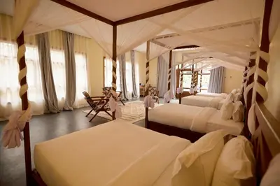 a bedroom with two beds and a large mirror at Arusha Farm House in Arusha