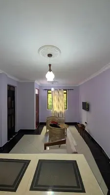 a living room with a couch and a table at Kilimanjaro Helichrysum Homes in Arusha
