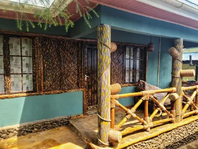 a building with wooden posts and windows on it at Langalanga Eco Farm in Nkoanrua