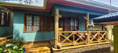 a house with a wooden fence in front of it at Langalanga Eco Farm in Nkoanrua