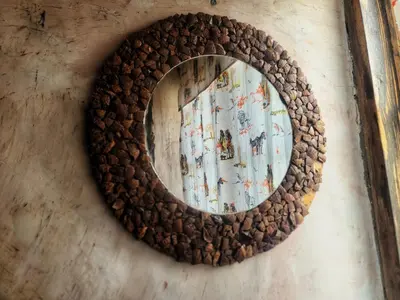 a round mirror on a wall with a map at Langalanga Eco Farm in Nkoanrua