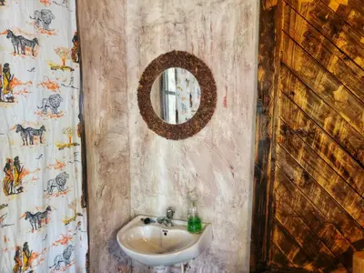 a bathroom with a sink and a mirror at Langalanga Eco Farm in Nkoanrua