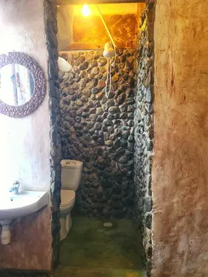 a stone bathroom with a sink and a toilet at Langalanga Eco Farm in Nkoanrua