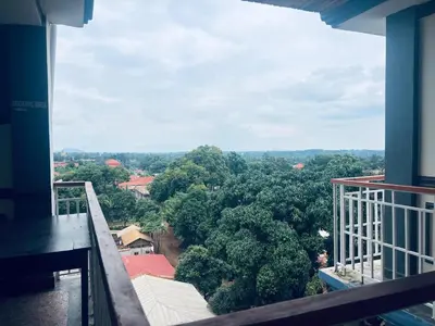 a balcony with a view of a forest of trees at Elly Villa Hotel in Moshi