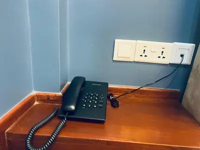 a black phone sitting on a desk in an office at Elly Villa Hotel in Moshi