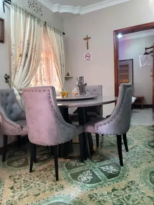 a dining room with a table and two chairs at Cape Haven in Arusha