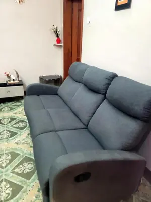 a blue couch sitting in a living room at Cape Haven in Arusha