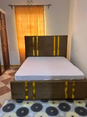 a bed sitting in a room with a mattress at Osim Homes in Arusha