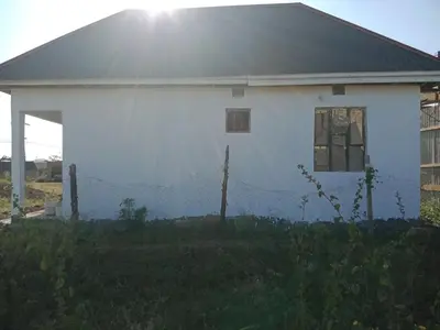 a white house with a fence in front of it at World Heart Africa Experience in Arusha