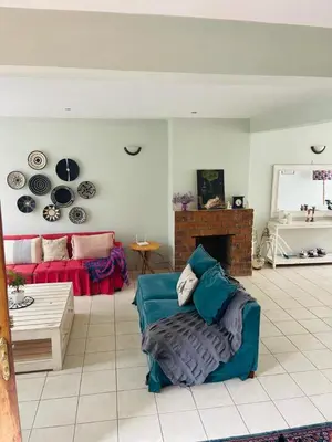 a living room with a couch and a fireplace at LAVENDER Residence Arusha in Arusha