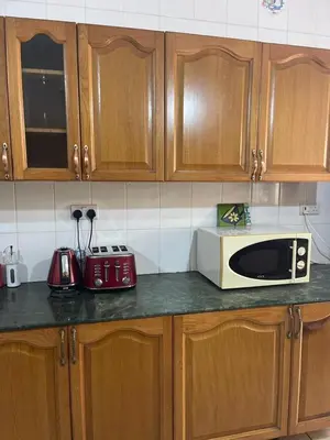 a kitchen counter with a microwave and a toaster at LAVENDER Residence Arusha in Arusha