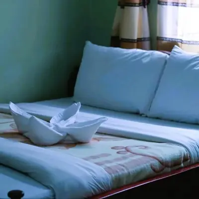 a bed with two white bowls on top of it at Otakef Motel in Arusha