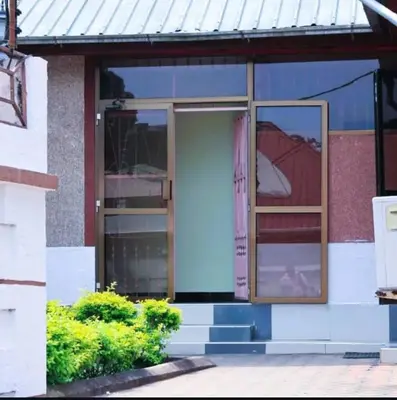 an open door of a house with a window at Otakef Motel in Arusha