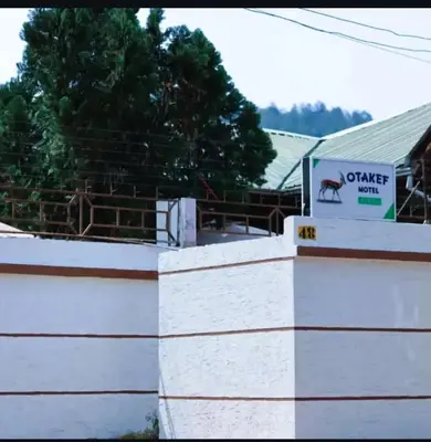 a building with a sign that reads camel farm at Otakef Motel in Arusha