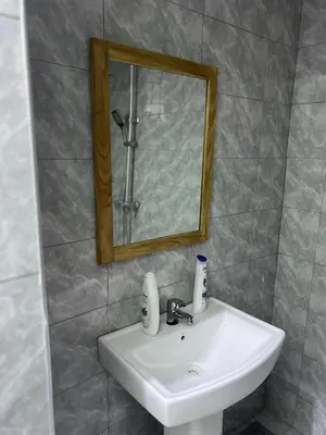 a white sink in a bathroom with a mirror at Upendo Moja House in Nkoanrua