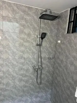 a shower with a shower head in a bathroom at Upendo Moja House in Nkoanrua